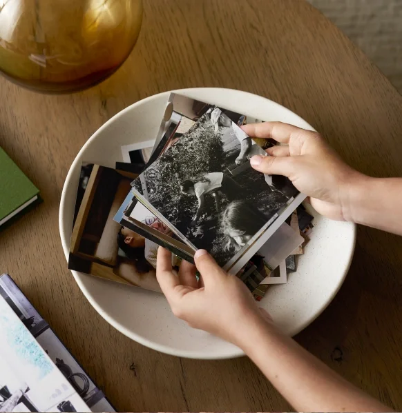 Printed photographs collected in a decorative bowl