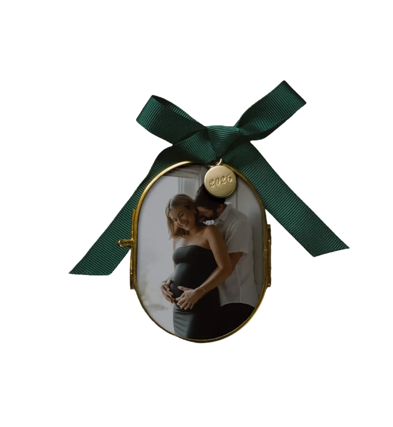 Pressed glass photo ornament with a green ribbon