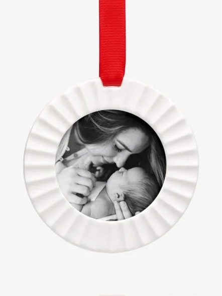 A baby's first Christmas photo in a porcelain ornament