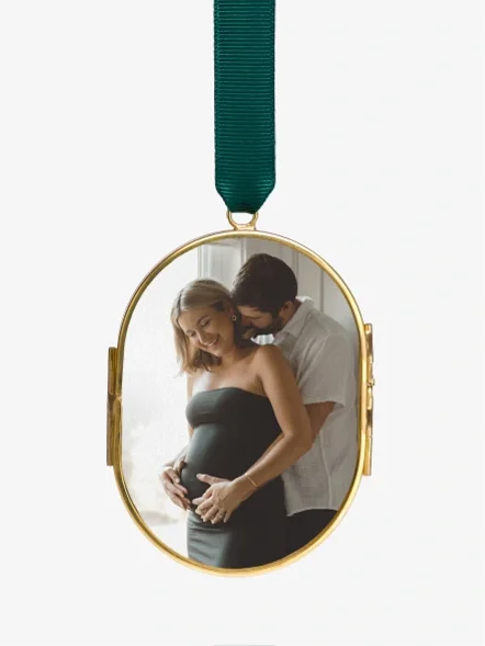 A grandparent and grandchild in a pressed glass ornament