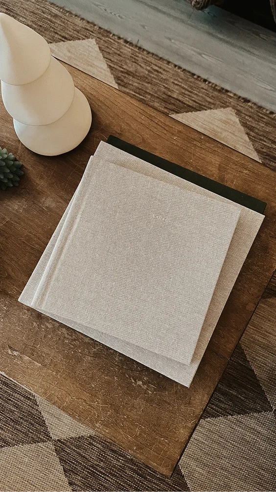 White layflat photo album on a wooden table