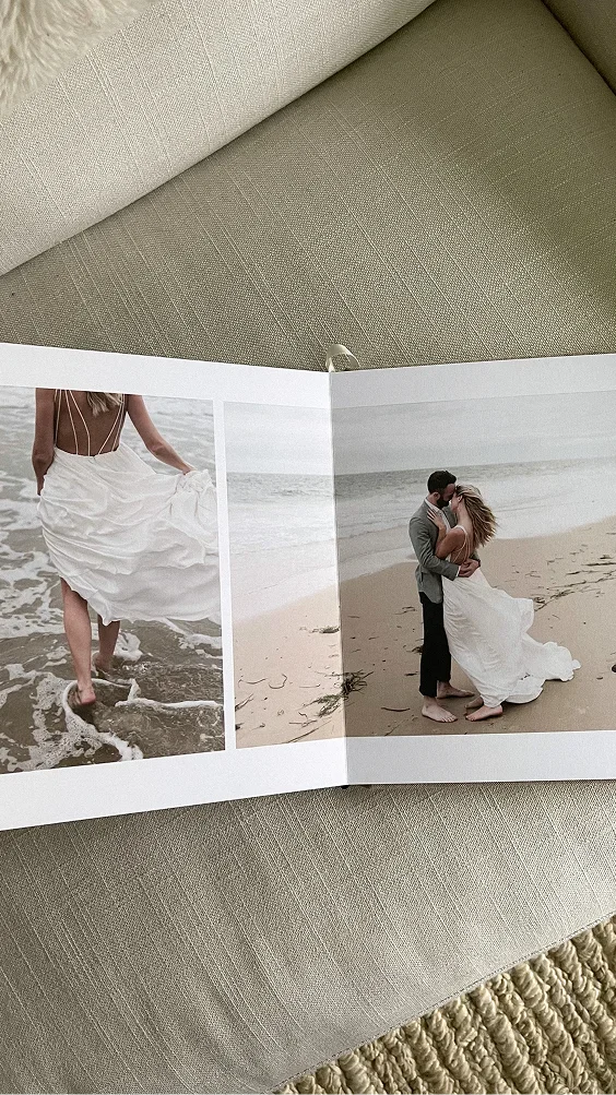Open signature layflat album showing wedding photos
