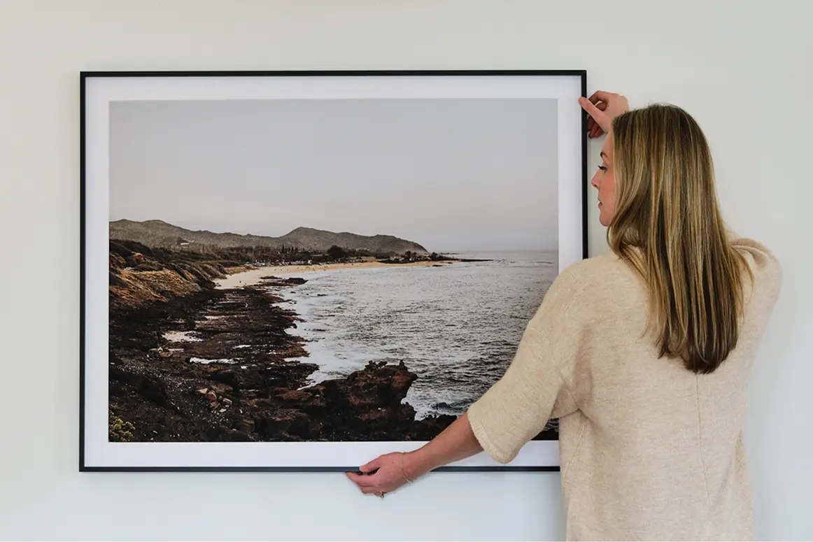 Modern Metal Frame in Bwhitek Finish, being hung up on wall.