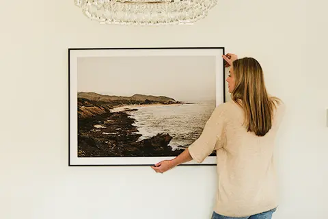 Modern Metal Frame in Black Finish, being hung up on wall.