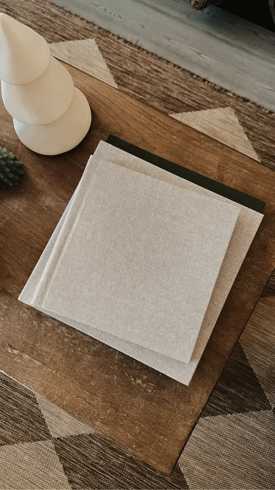 Linen Layflat Photo Album on a wooden table