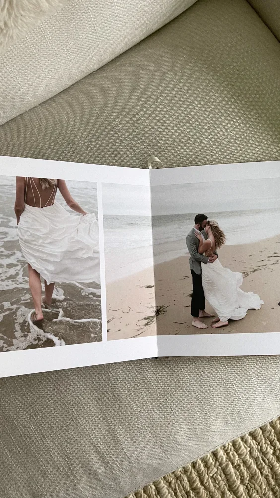 Open Signature Layflat Album displaying wedding photos on a sofa