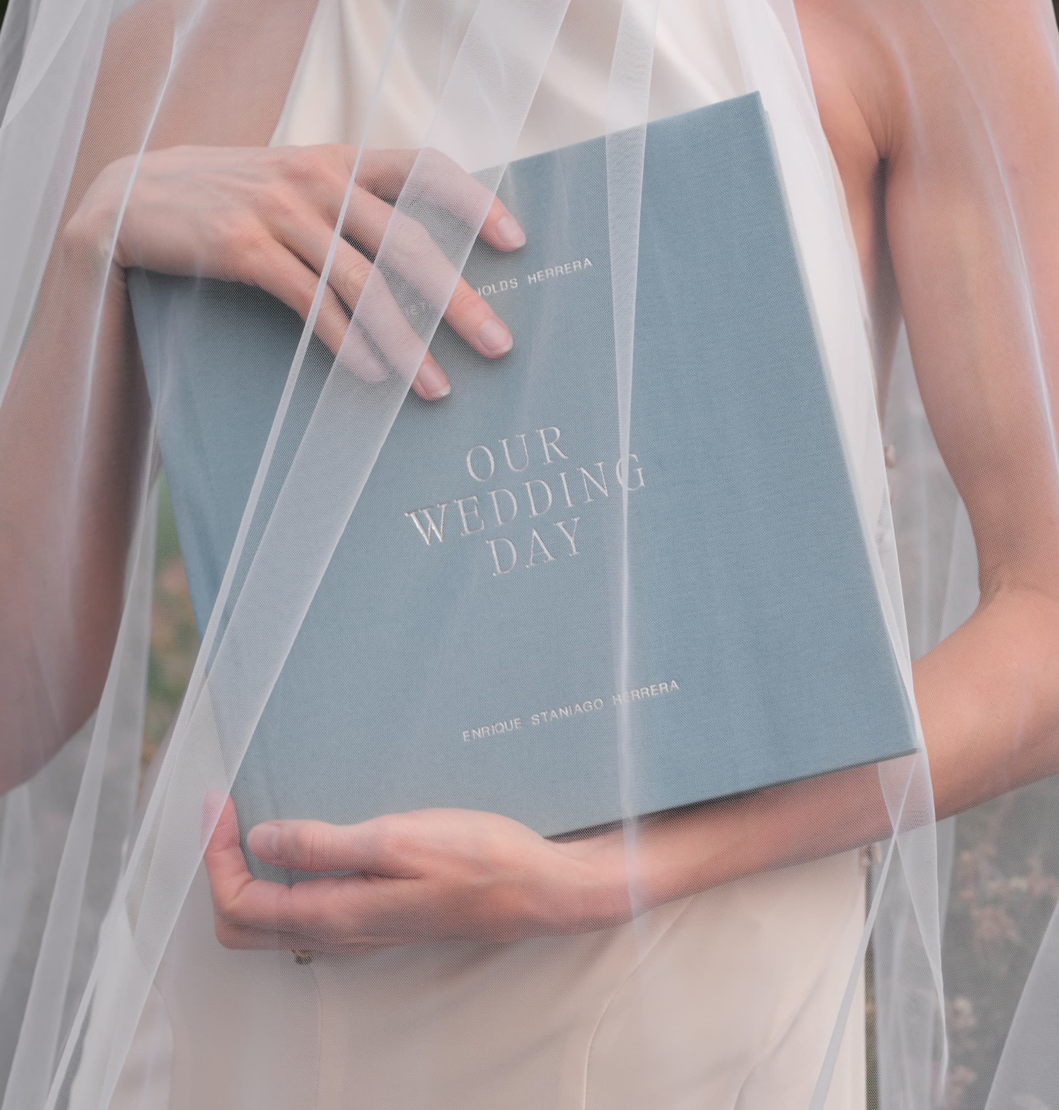 Bride holding a personalized wedding guest book