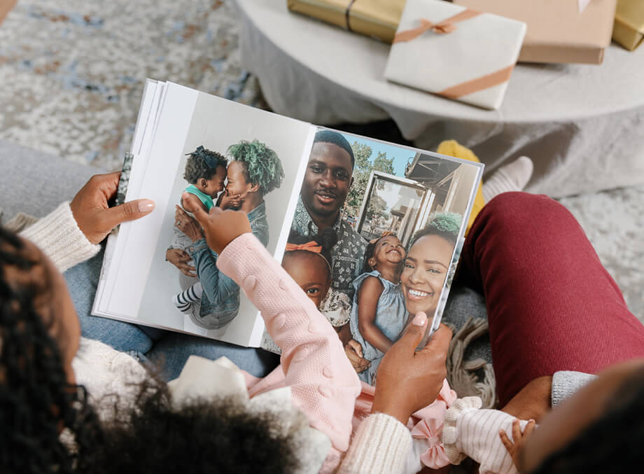 Family on couch flipping through photo book