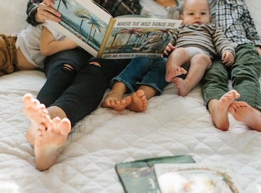 family flipping through photo book together