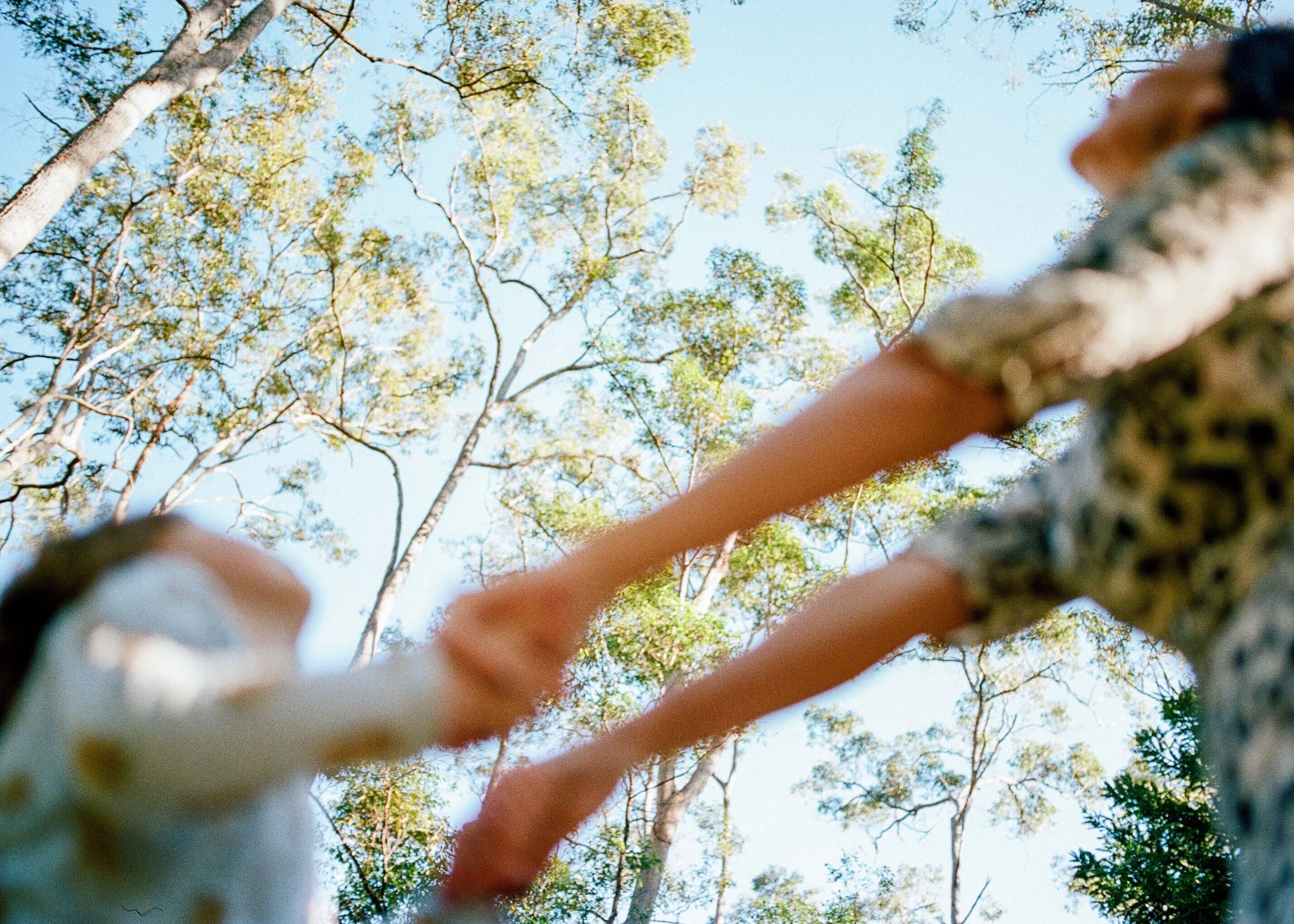 Blurred photo by Yan Palmer of mother and daughter swinging around hand in hand