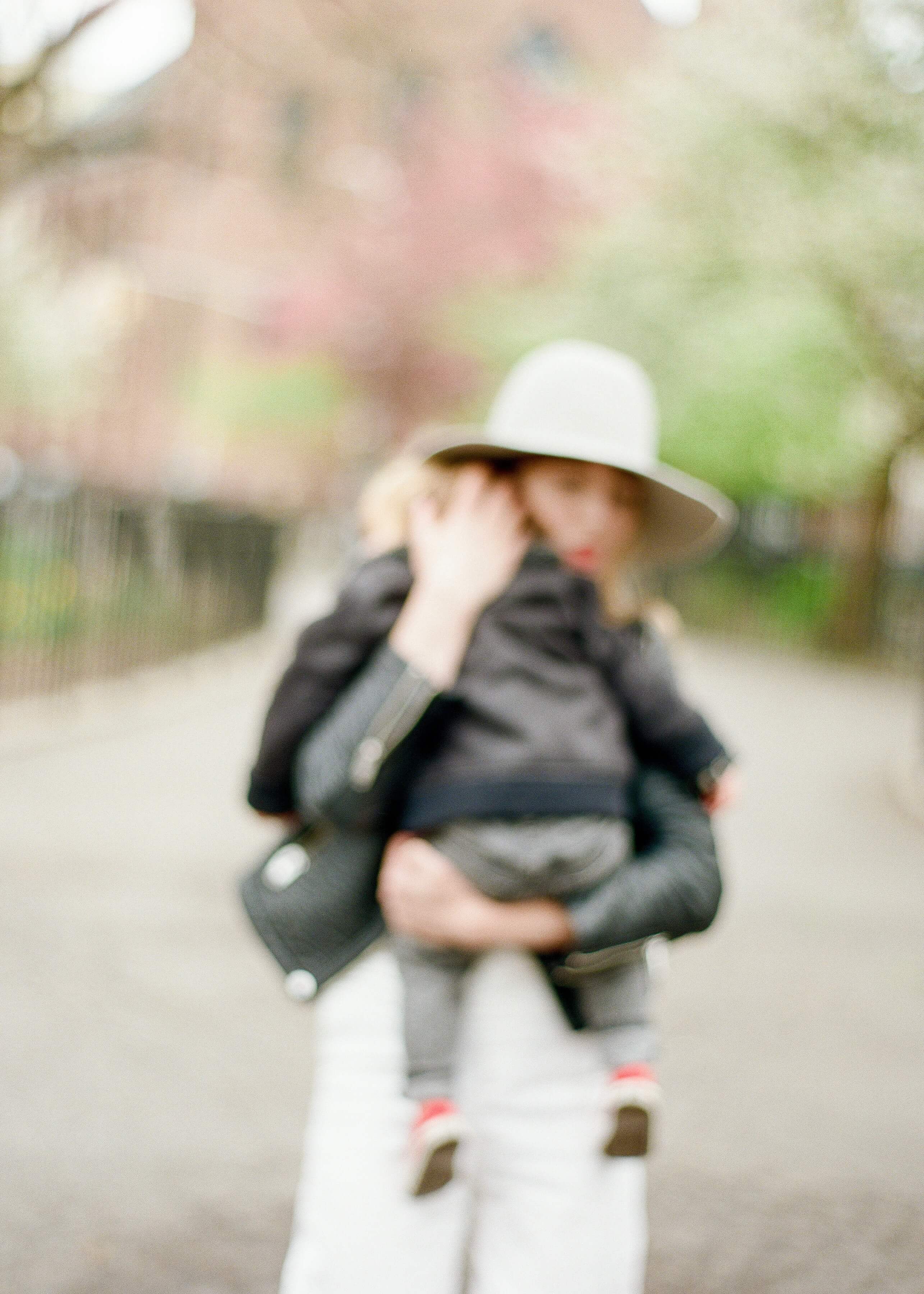 Blurred photo of mother holding baby as they walk