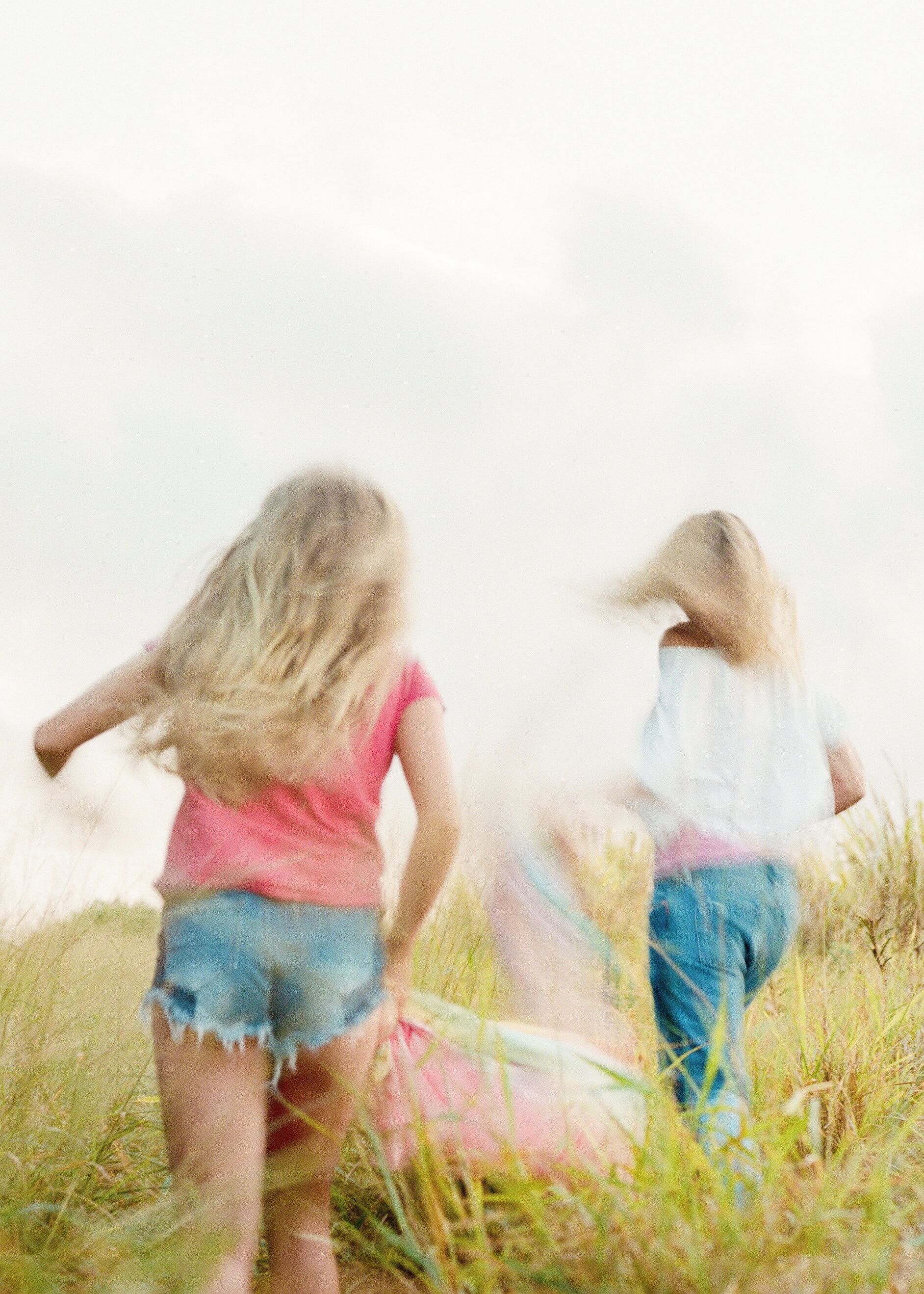 Blurred photo of little girls running in a field