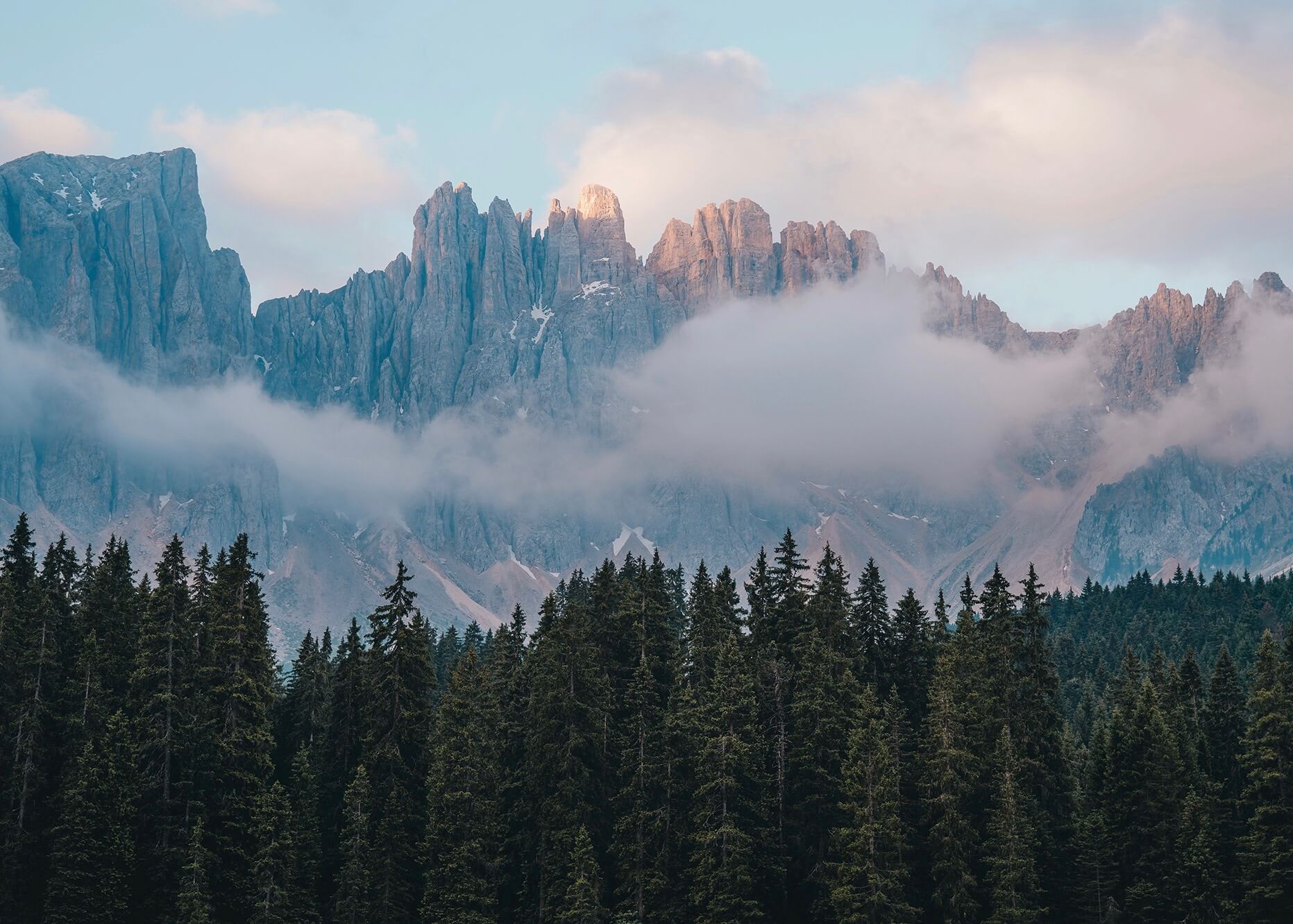 Emilie Ristevski photo of craggly mountain peaks behind the clouds