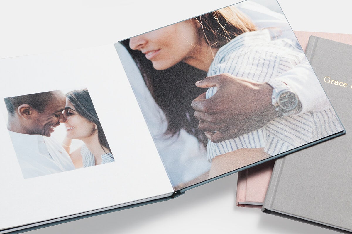 Photo book open to pictures of couple smiling at each other