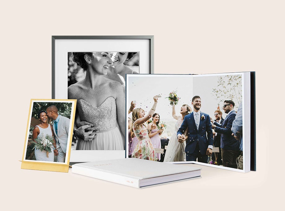 Wedding albums, photo prints, and more in front of tan backdrop