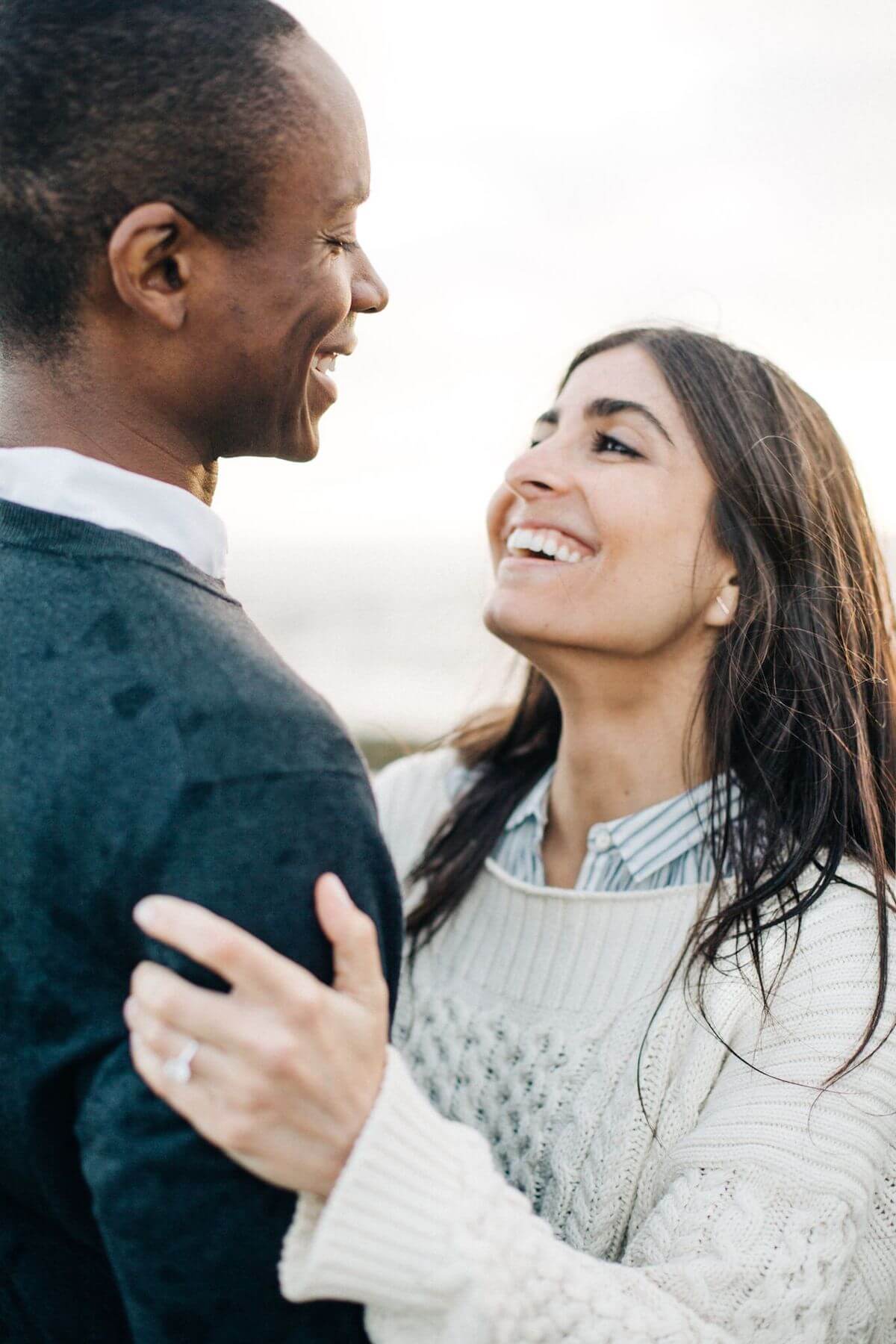 Couple smiling at each other for test photos taken as they figure out how to choose a wedding photographer