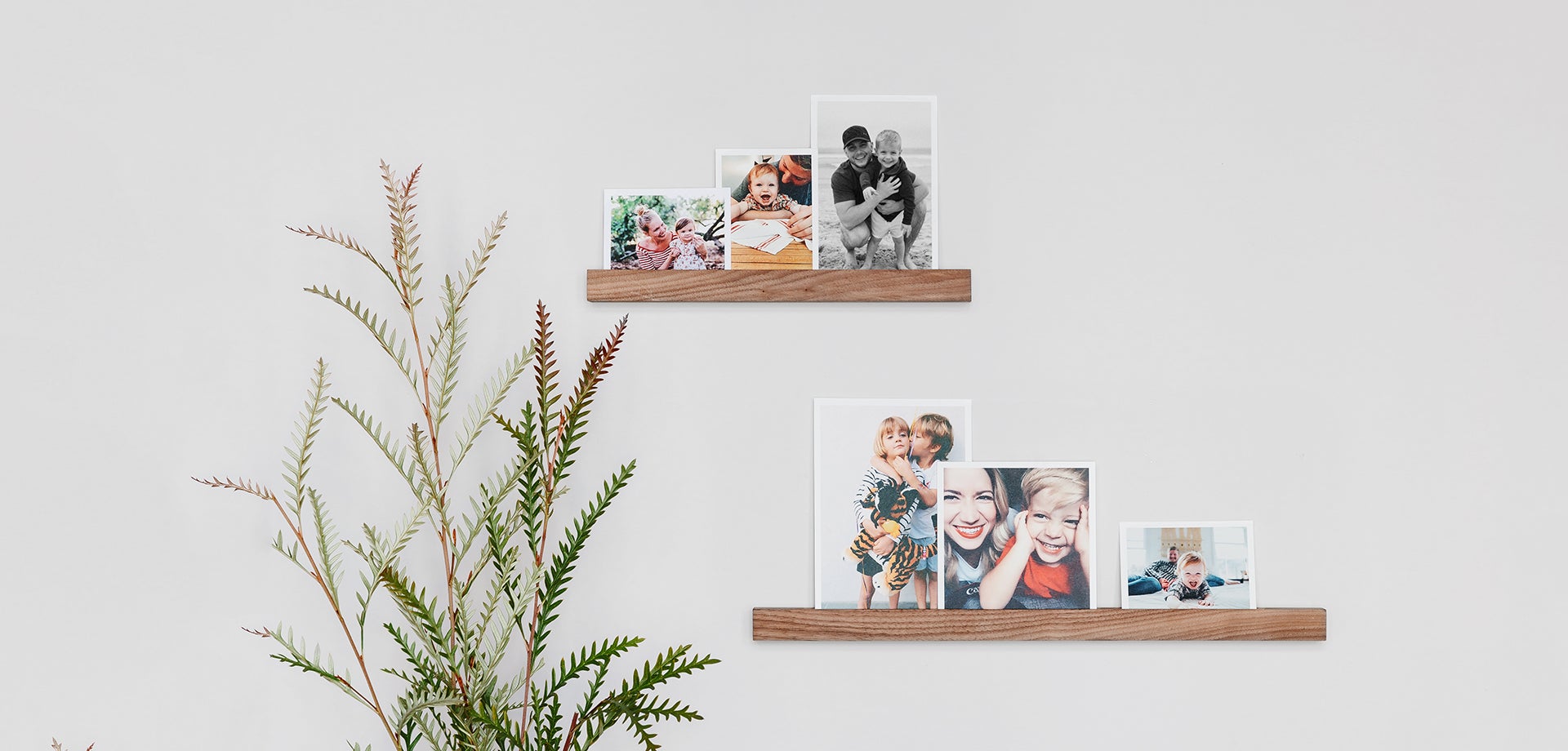 Photo display ideas in action in the form of prints on a wooden photo ledge