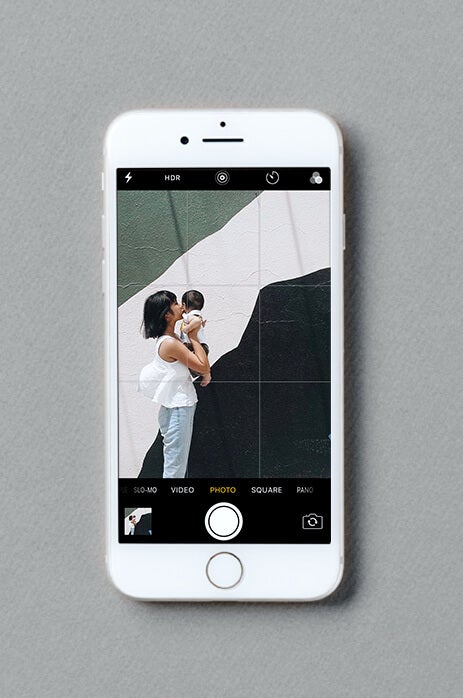iPhone screen using grid function to line up photo of woman and baby
