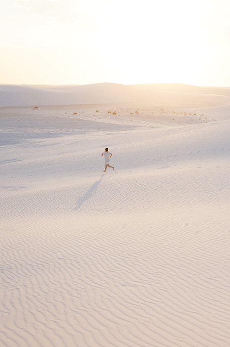 Photo of woman running across the sand that was on the iPhone screen in the previous image