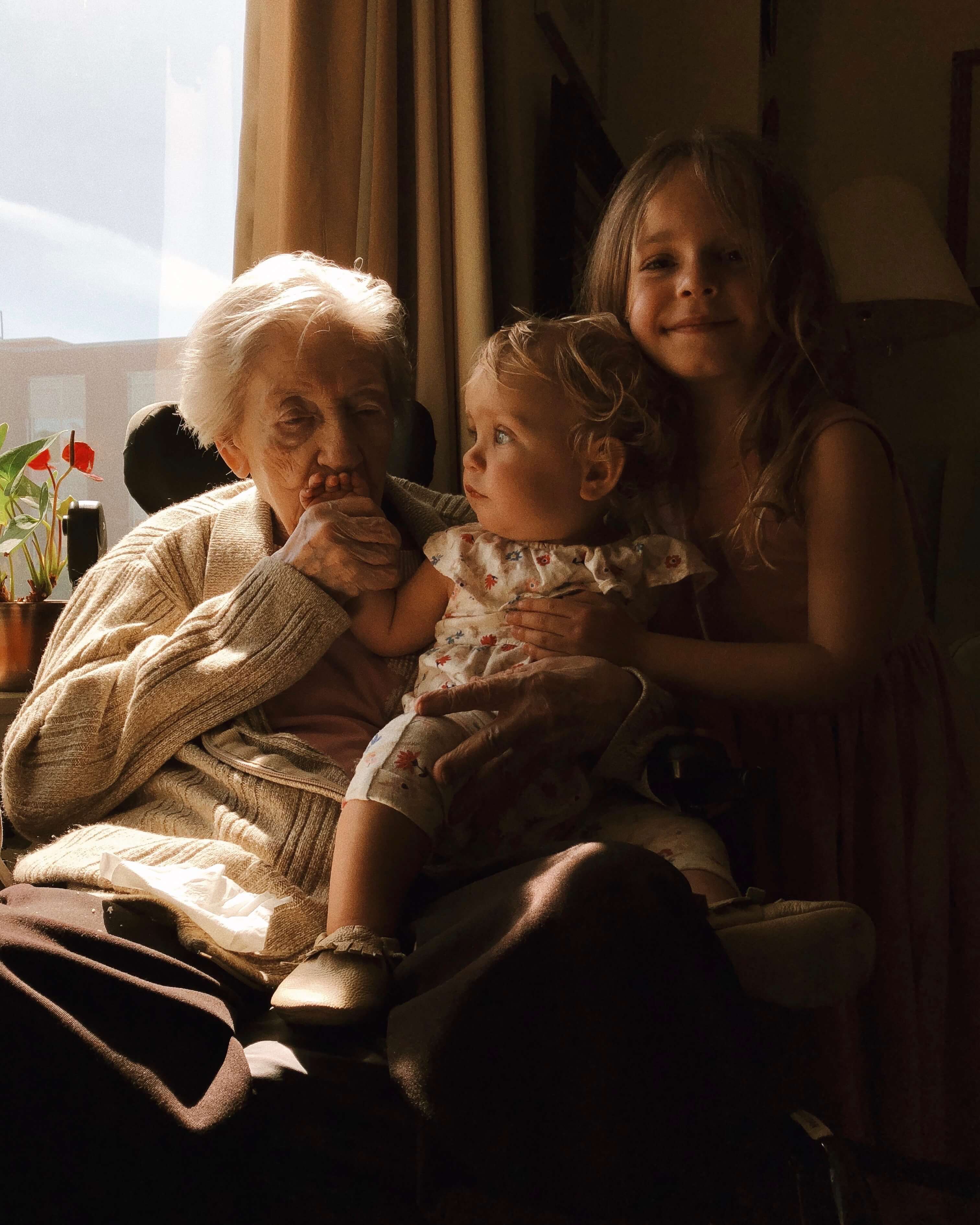 Grandmother with granddaughters by the window