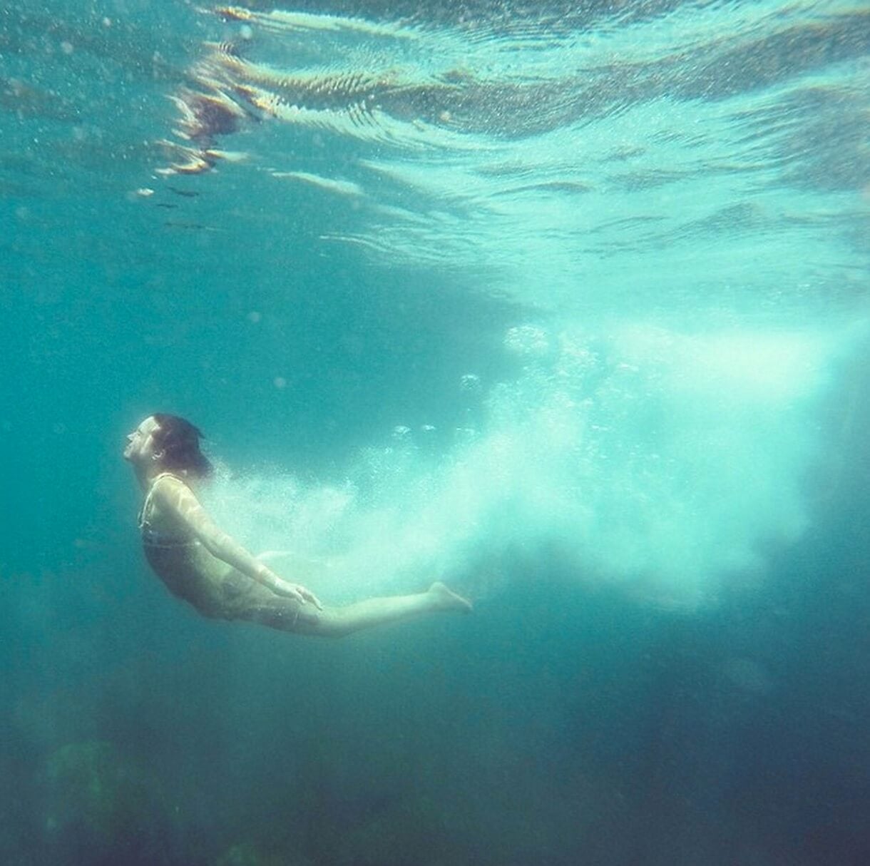 underwater photo of woman swimming