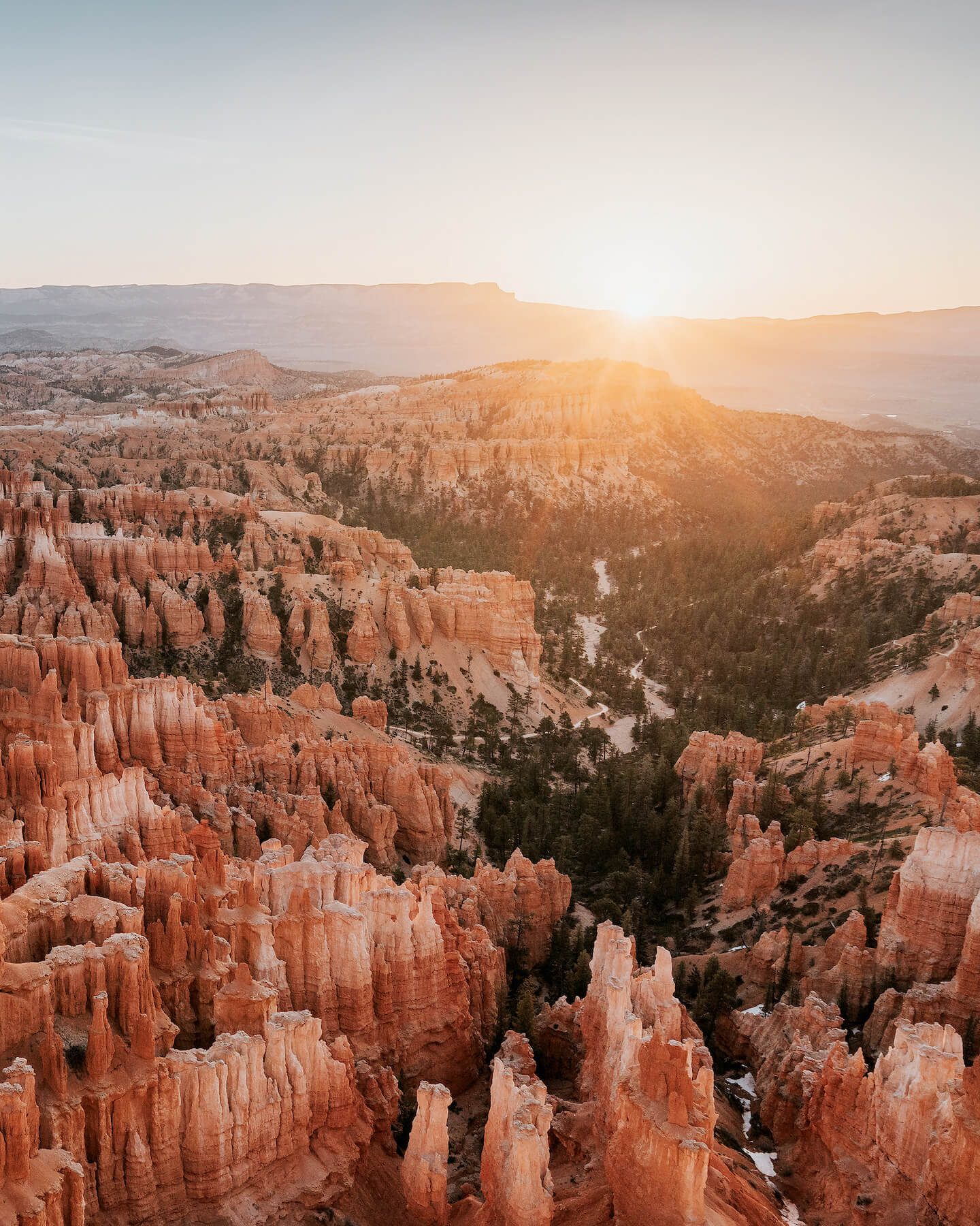 Sweeping view of Bryce Canyon's red rock formations at sunrise