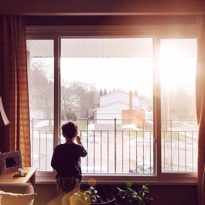 Photo of little boy in front of window from Days at Home album