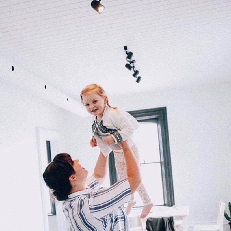 Photo of mother holding up little girl from Days at Home album