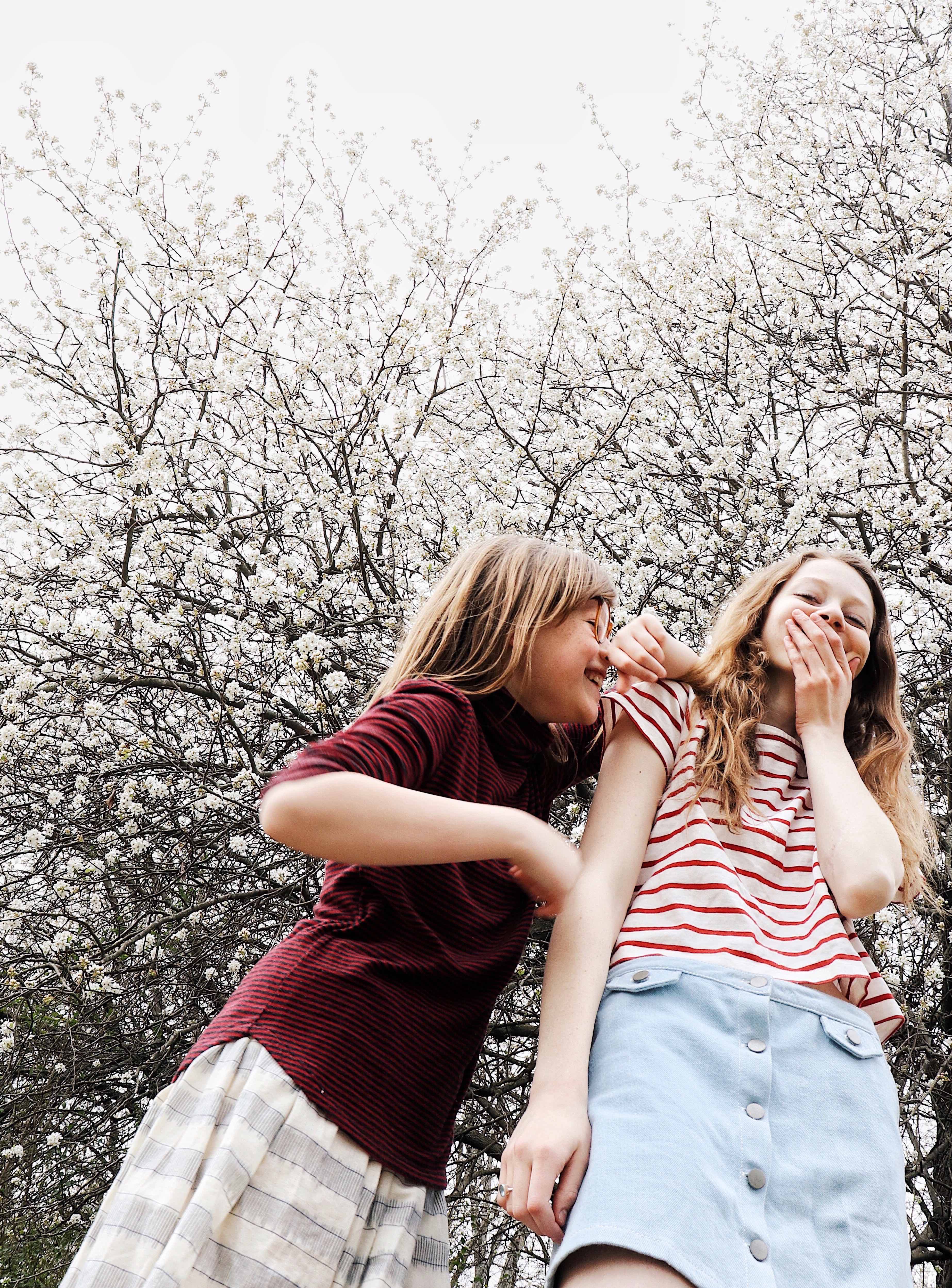 Photo of two young girls laughing and being silly