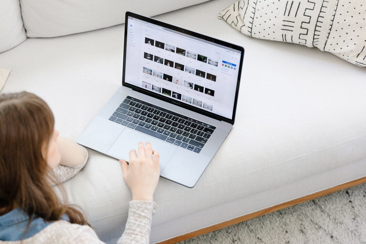 woman sorting through photos on computer